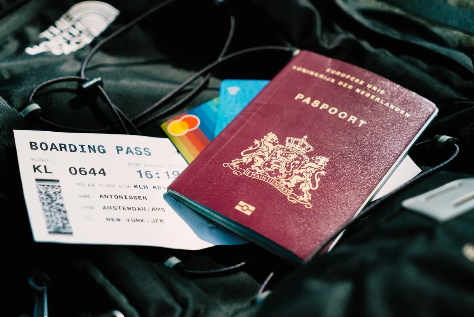 EU passport, boarding pass and bank cards lying on a travel bag